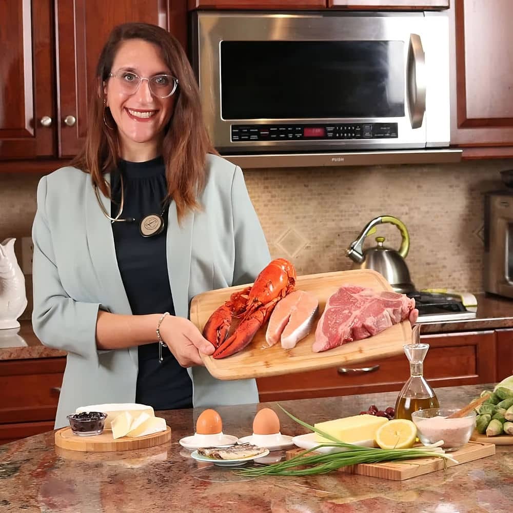 dr of metabolic medicine, Christine Najjar, holding meat on a cutting board